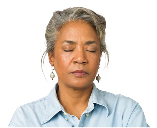 A woman meditating with her eyes closed